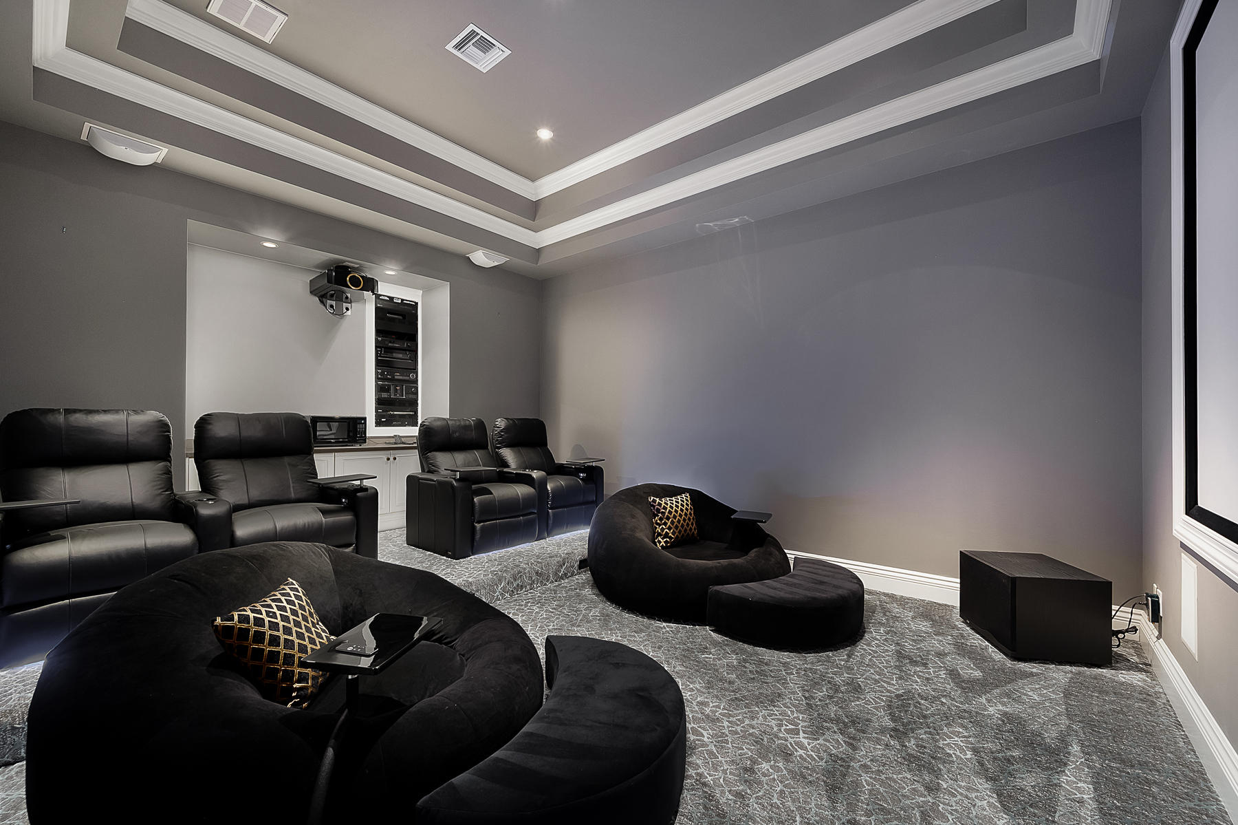 A unique feature of the house is the theatre which has motion seating, snack trays, USB ports, and under-mount lighting in the reclining chairs. Large floor chairs are a family favorite for watching movies and sporting events with surround sound.